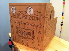 a cardboard box sitting on top of a wooden table