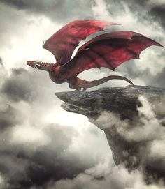 a red dragon flying over a cliff in the clouds