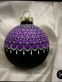 a purple and black ornament with white dots on it