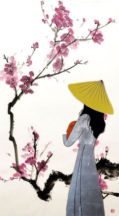 a woman with a yellow hat is standing in front of a flowering tree