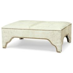 the foot stool is made out of sheepskin and has gold trimmings on it