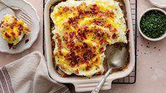 a casserole dish with mashed potatoes and bacon