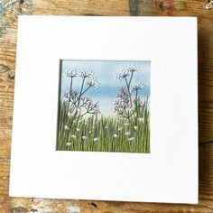 a painting of some white flowers on a wooden table with blue sky in the background