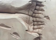 an image of some kind of art work in the sand that looks like it has been carved