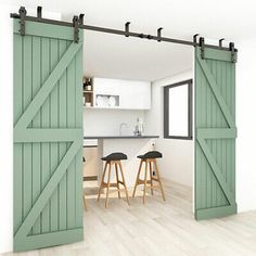 an open door leading to a kitchen with stools in front of the bar area