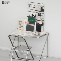 a laptop computer sitting on top of a metal chair next to a desk with flowers