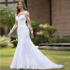 a woman in a wedding dress standing outside