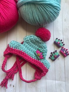 two balls of yarn and some crocheted items