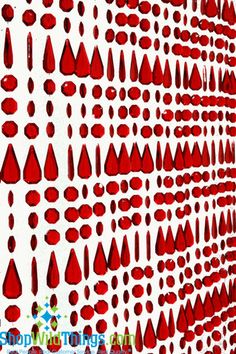 a red and white wall with lots of dots on it