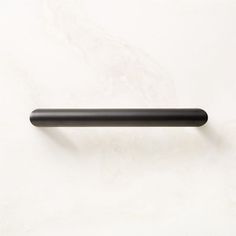 a black handle on a white wall