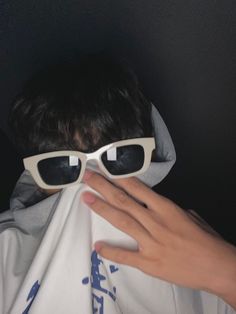 a person with sunglasses covering their face