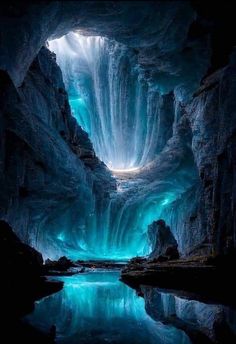 the inside of an ice cave with water flowing from it's walls and lights shining down