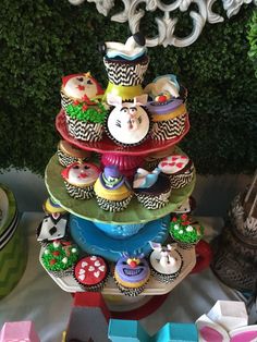 cupcakes are stacked on top of each other in the shape of a tower