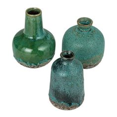 three green vases sitting next to each other