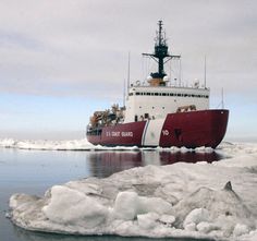 a large boat floating on top of ice covered water