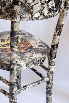 an upholstered wooden chair with many pictures on it's back and seat