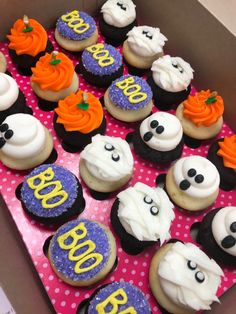 a box filled with cupcakes covered in frosting and decorated to look like ghost faces