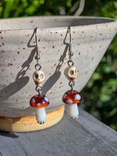 Earrings made from white stone skull beads and glass brown mushroom charms. Findings are silver tone metal. Mushroom Earrings Beads, Unique White Jewelry With Mushroom Design, Unique White Mushroom Design Jewelry, Jewelry With Beads, Boho Beads, Mushroom Jewelry, Skull Beads, Brown Mushroom, Mushroom Earrings