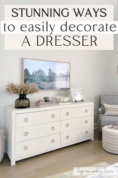 a white dresser sitting in a bedroom next to a bed with pillows on top of it