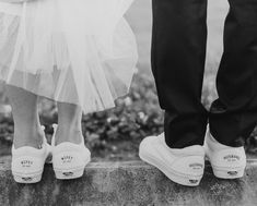 black and white photo of bride and groom's feet with tulle skirt on