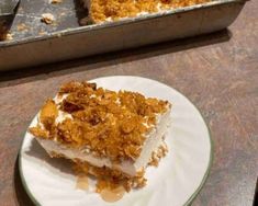 a piece of cake sitting on top of a white plate next to a baking pan