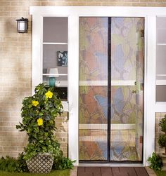 the front door is decorated with yellow flowers and greenery, along with a potted plant