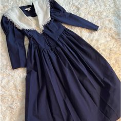 Classically Designed Vintage Dark Navy Dress With Linen Collar & Linen Button Breast Cover. Slightly Puffed Sleeves. Cloth Button Down Front. Flared Skirt. Very Nice Condition. Perfect W My Navy Ferragamo’s:) Navy Vintage Dress, Classic Fitted Long Sleeve Prairie Dress, Fitted Long Sleeve Prairie Dress With Buttons, Classic Fitted Dress With Smocked Bodice, Classic Puff Sleeve Dress With Buttons, Cotton Victorian Dress For Formal Occasions, Fitted Victorian Dress With Buttons, Elegant Fitted Prairie Dress With Buttons, Formal Cotton Dress With Buttons