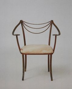 a chair that is made out of wood and has rope on the backrests