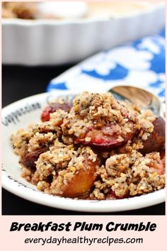 a white plate topped with fruit crumbled next to a bowl of oatmeal