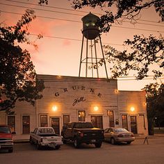 an old building with a water tower in the background