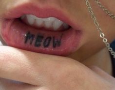 a close up of a person's mouth with the word moon written on it