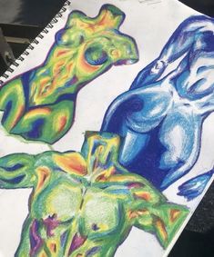 a drawing of three different colored figures on paper