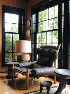 a living room filled with furniture and large windows