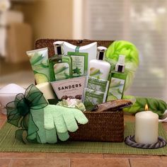 a basket filled with green items on top of a table next to a lit candle