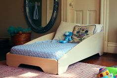 a child's bed that is made to look like it has an animal pillow on top