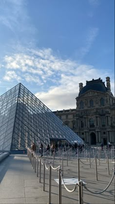 a large glass pyramid in front of a building