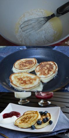 pancakes with blueberries are being prepared in a skillet