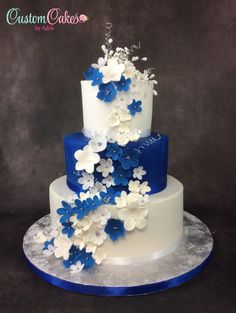 a three tiered cake with blue and white flowers