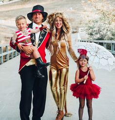 a man and two children are dressed in costumes