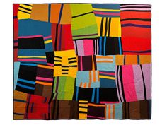 a multicolored patchwork quilt is displayed on a white background with black, red, yellow and blue stripes