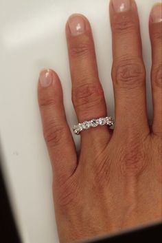 a woman's hand with a diamond ring on it