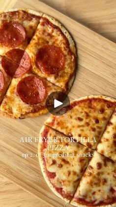 two slices of pizza sitting on top of a wooden cutting board next to each other