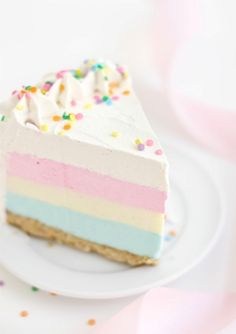 a slice of cake on a plate with sprinkles