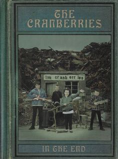 the cranberries album cover with three men standing in front of a pile of debris