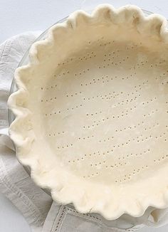 an uncooked pie dish on a white table