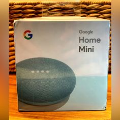 the box for google home mini is shown in front of a wicker basket with it's lid open