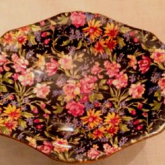 an ornately decorated dish with flowers on it