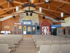 an empty church with rows of chairs in it