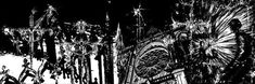 black and white photograph of chandeliers hanging from the ceiling in a dark room