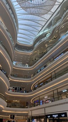 the inside of a shopping mall with chandeliers hanging from it's ceiling